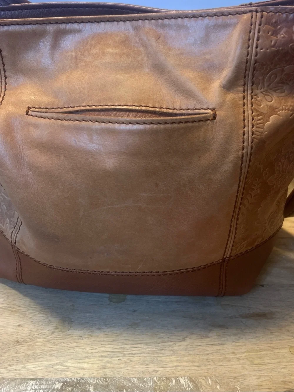 The Sak tan leather crossbody with beige interior